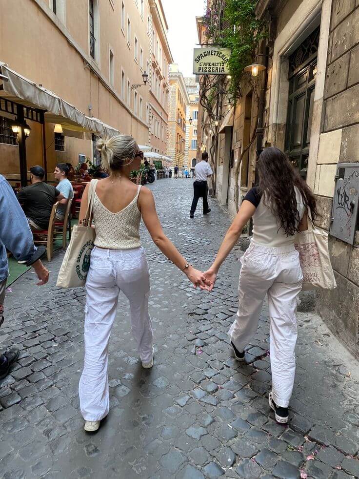 Sober women walking hand in hand while building community and making friends as adults